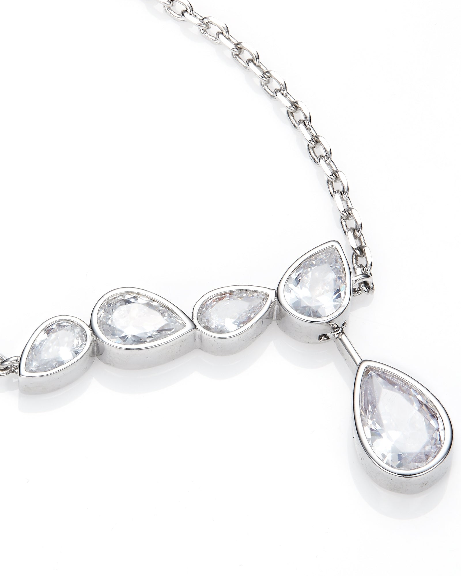Silver necklace with teardrop-shaped clear stones on a white background