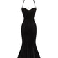 Black velvet evening gown with thin straps on a white background