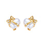 Pair of gold and pearl heart-shaped earrings on a white background