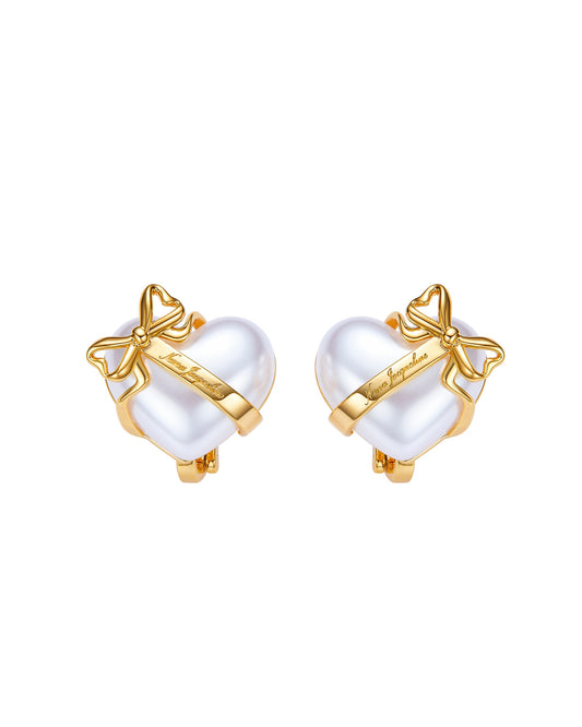 Pair of gold and pearl heart-shaped earrings on a white background