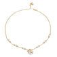 Gold necklace with pearl accents on a white background