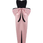Pink and black velvet and satin maxi dress with a large bow on the back on a white background