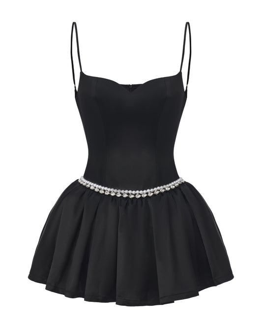 Black dress with thin straps and pearl belt on a white background