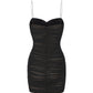 Black spaghetti strap mini dress on a white background