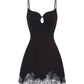 Black slip dress with lace trim on a white background