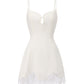 White slip dress with lace trim on a white background