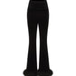 Black velvet and wool flared pants with fur trim on a white background