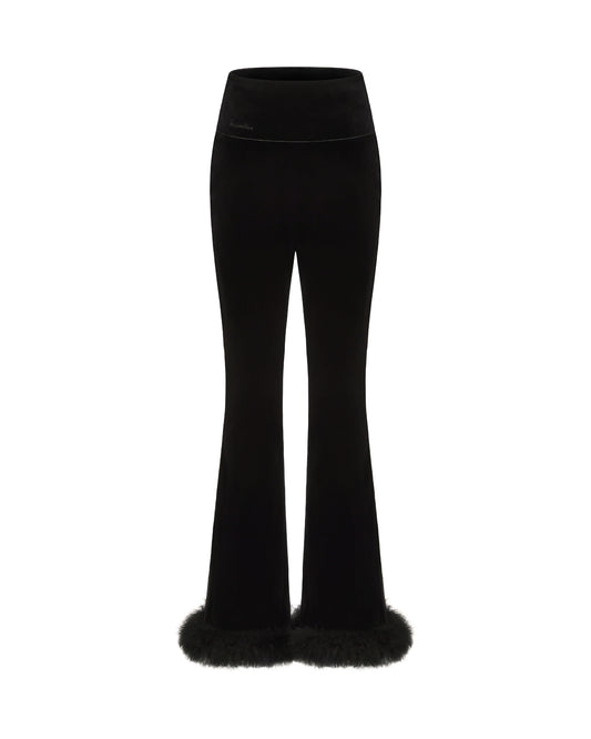 Black velvet and wool flared pants with fur trim on a white background