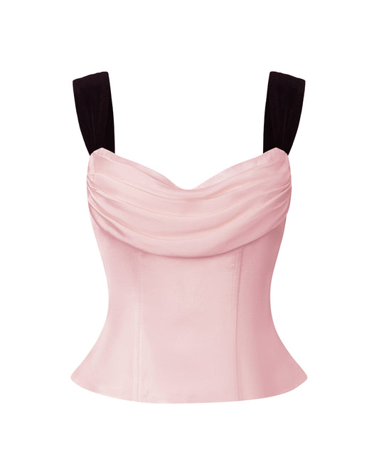 Pink top with black straps on a white background