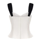 White top with black straps on a white background