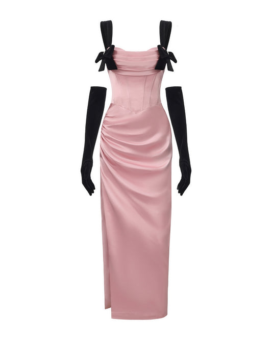 Pink evening gown with black bow straps and gloves on a white background