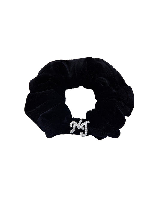Black velvet scrunchie with a silver logo on a white background