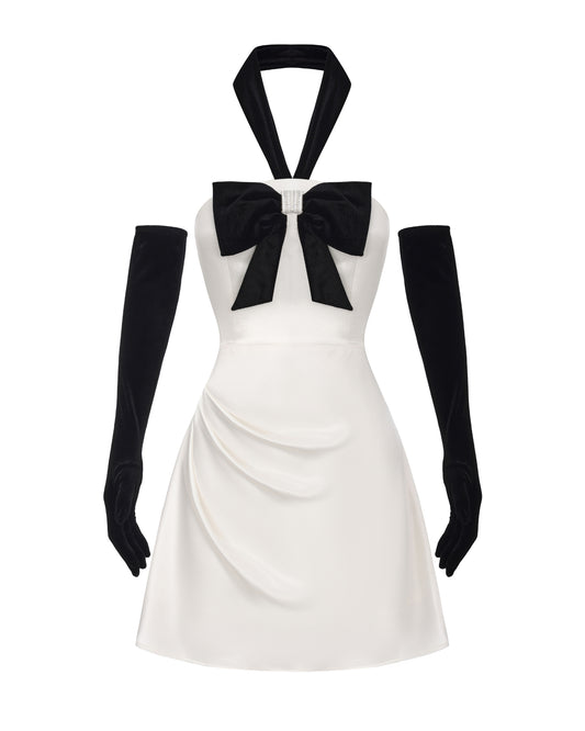 White dress with black bow and gloves on a white background