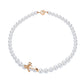 Pearl necklace with a gold bow clasp on a white background