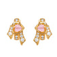 Gold earrings with pink stones and clear gemstones on a white background