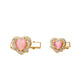 Heart-shaped hair clips with pink centers and gold frames on a white background
