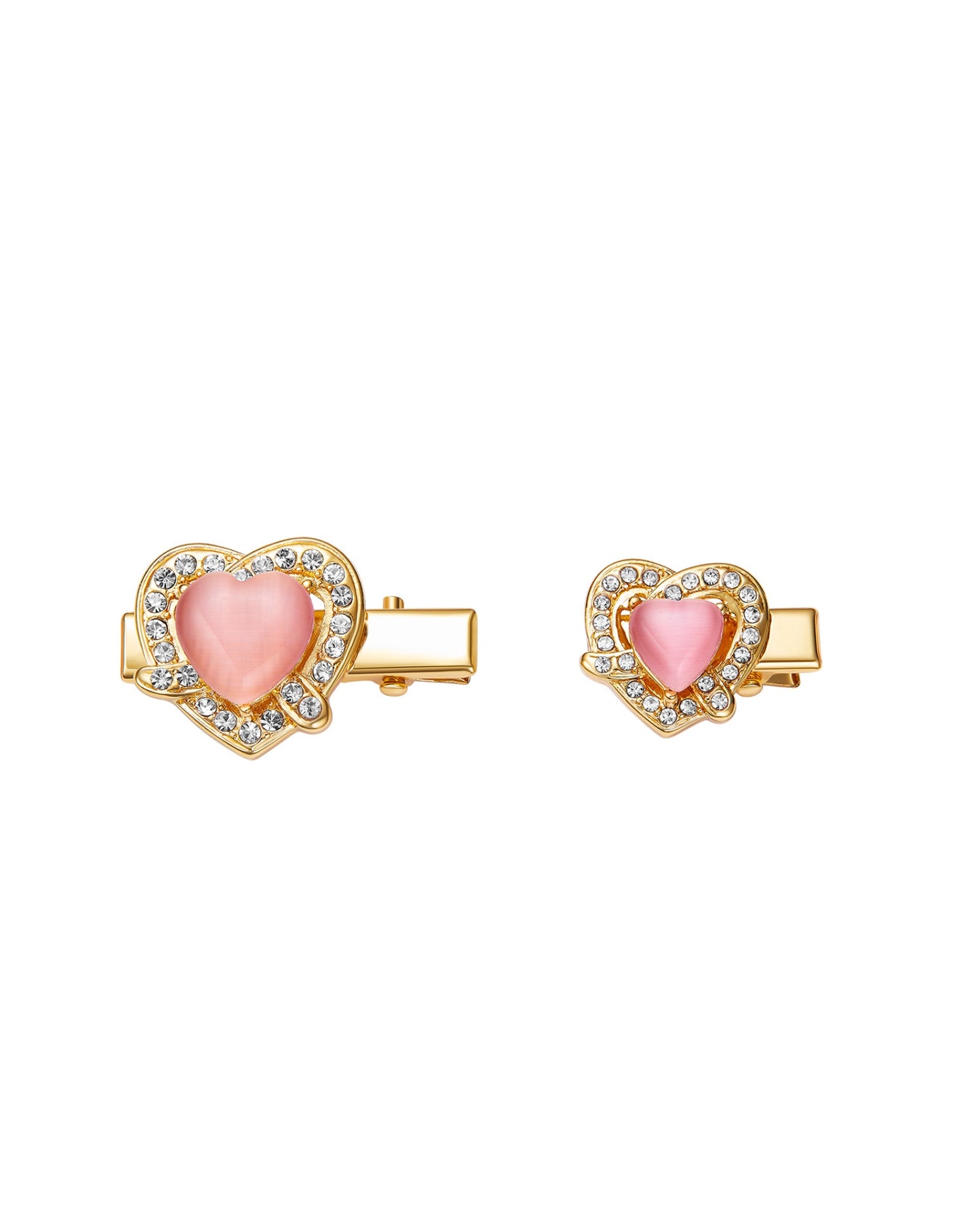 Heart-shaped hair clips with pink centers and gold frames on a white background