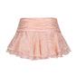 Pink skirt with ruffled layers on a white background
