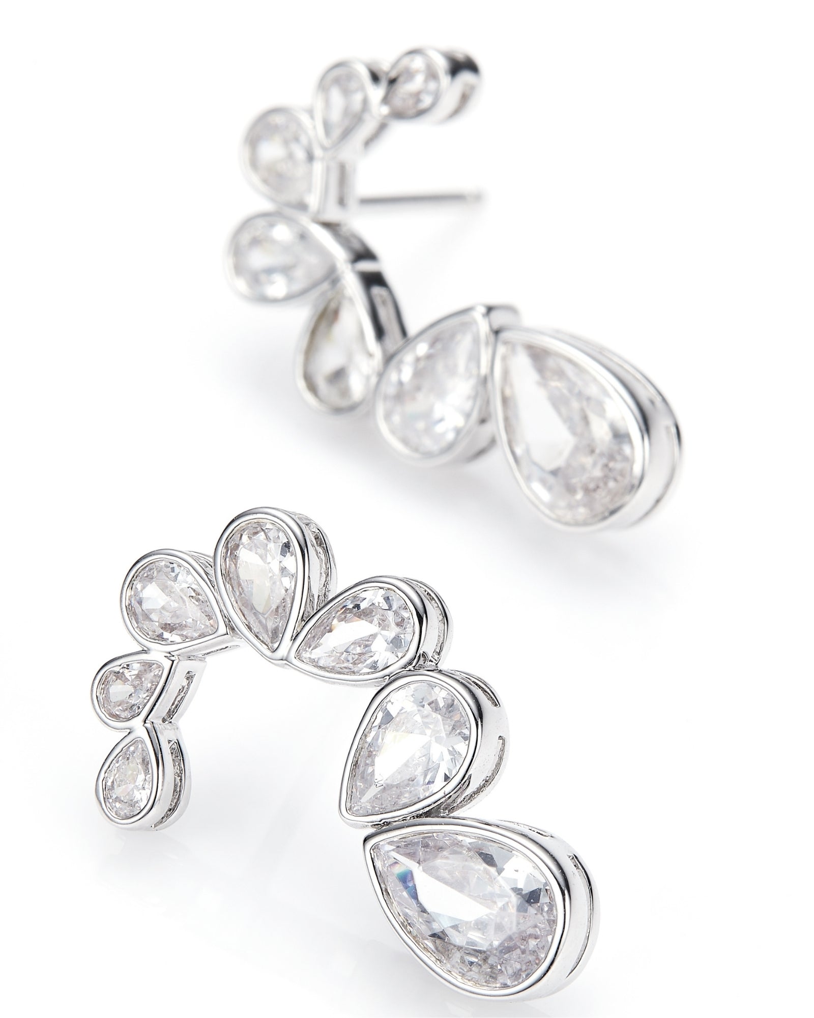 Pair of silver earrings with teardrop-shaped gemstones on a white background