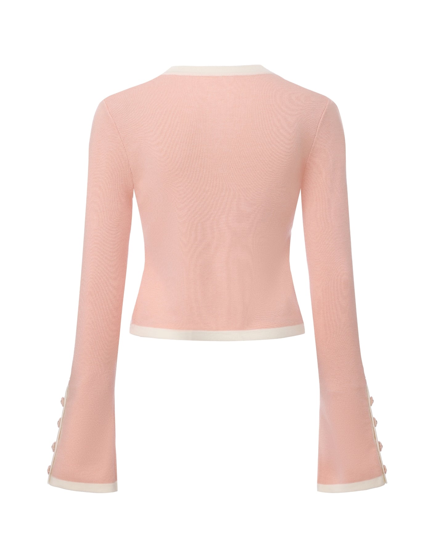 Pink knit cardigan with white trim part of a set on a white background