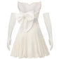 White mini dress with a large bow and matching gloves on a white background
