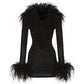 Black diamond wool mini dress with feathered trim on a white background