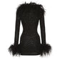 Black diamond wool mini dress with feathered trim on a white background