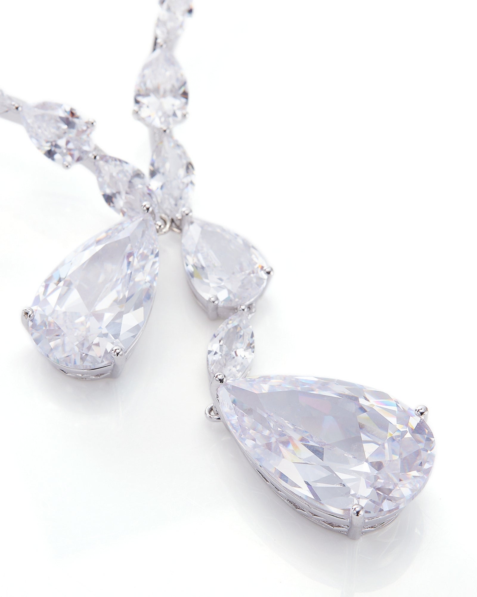 Teardrop-shaped crystal silver necklace on a white background
