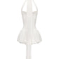 White mini halter dress with thin long straps on a white background