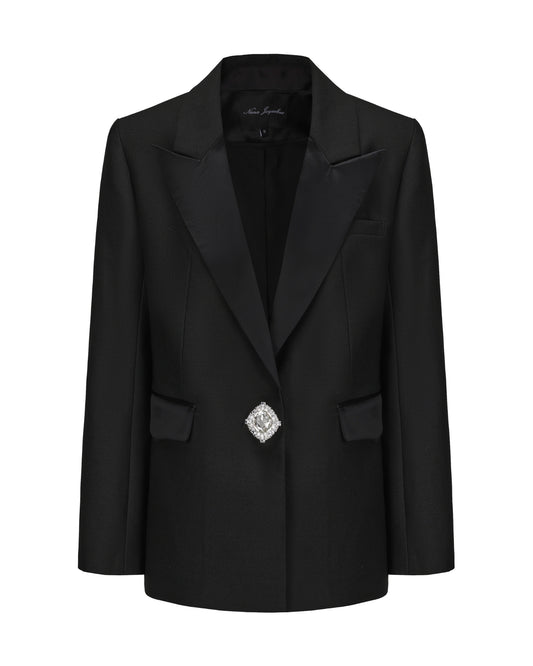Black blazer with a decorative brooch on a white background