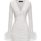 White dress with feathered hem on a white background