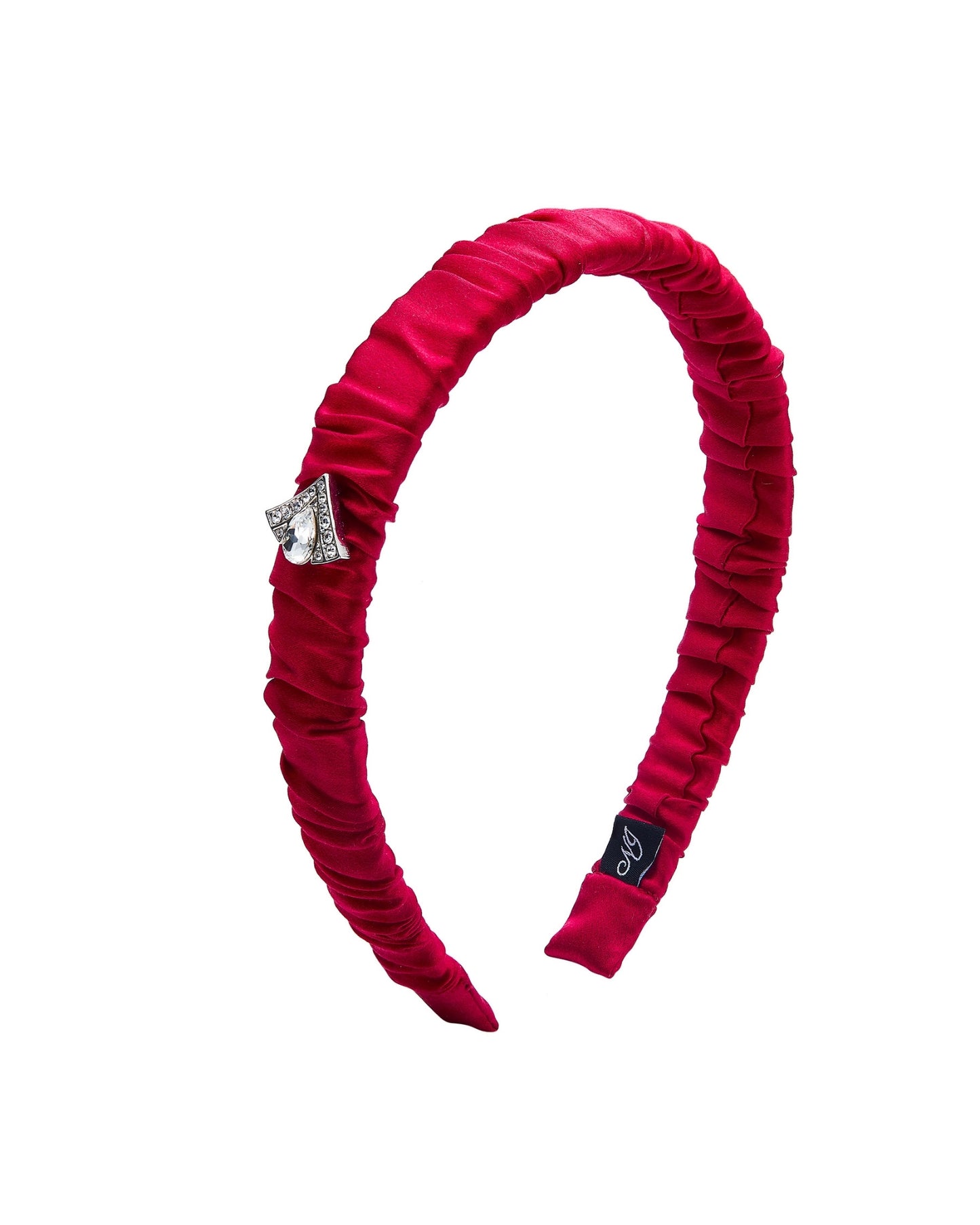 Red ruched silk headband with a decorative triangle shaped gemstone on a white background