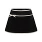 Black mini velvet skirt with white trim and bow detail