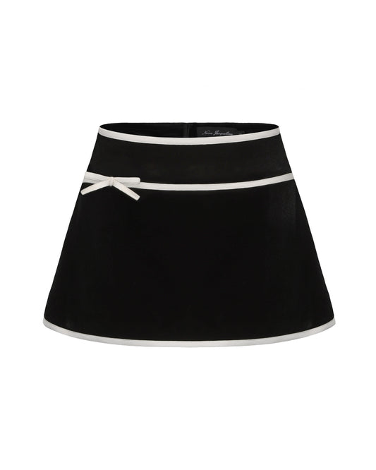 Black mini velvet skirt with white trim and bow detail