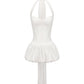 White mini halter dress with a pleated skirt on a white background