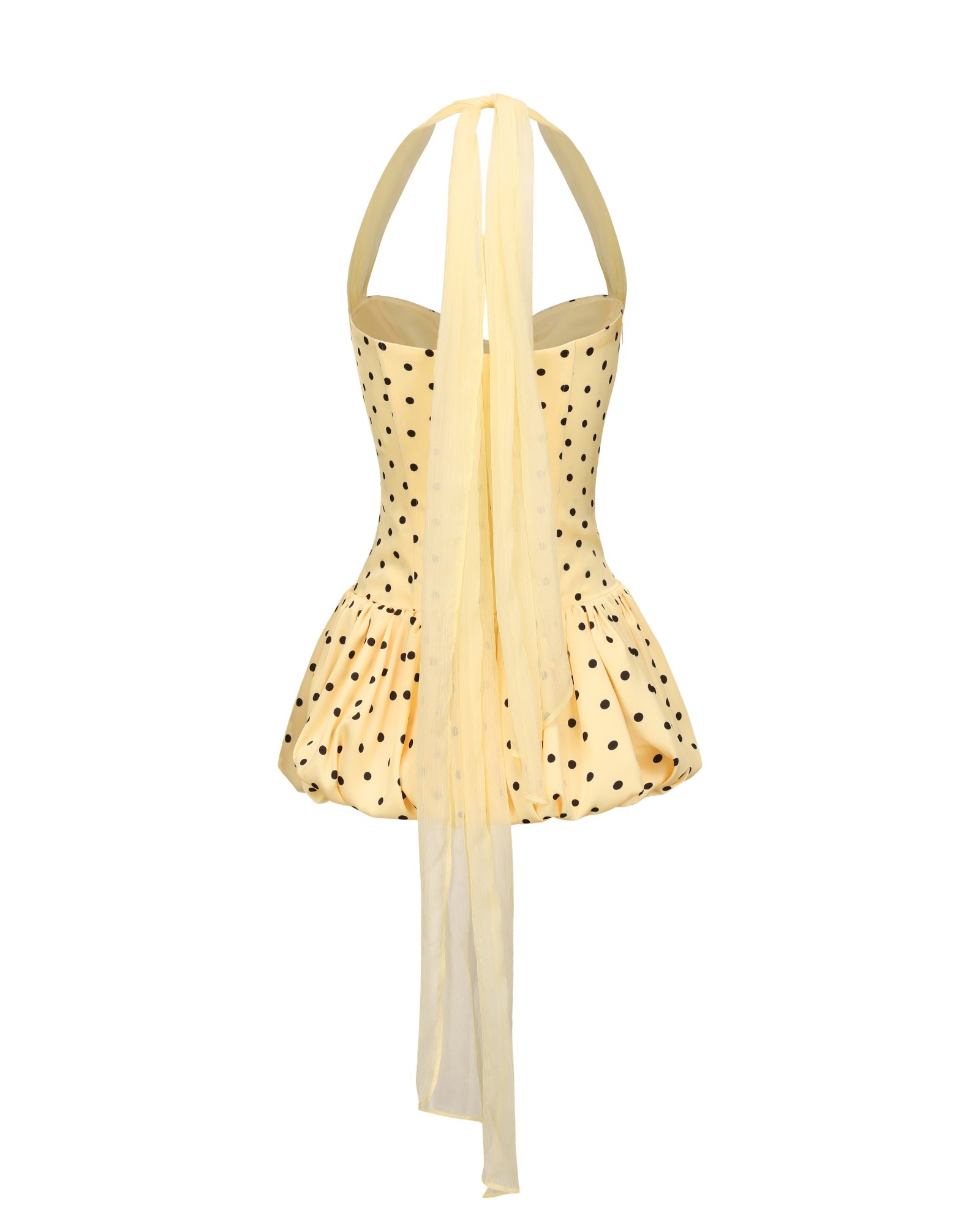 Yellow mini dress with polka dot pattern on a white background