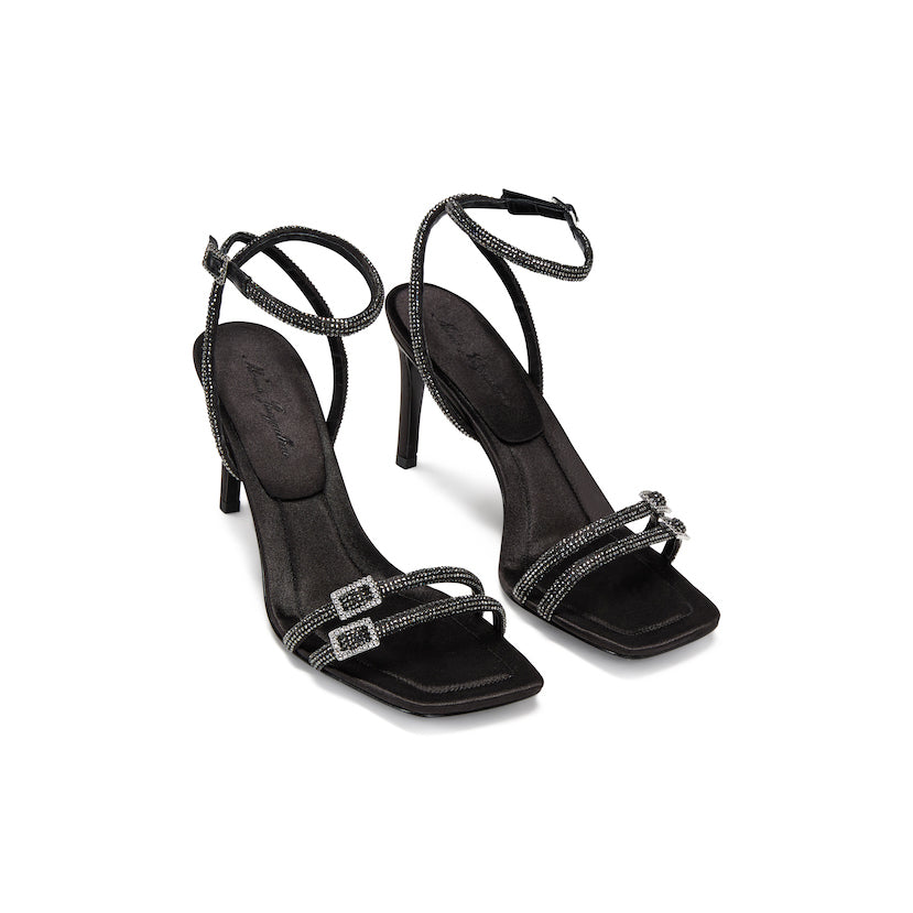 black sandals with black straps, each featuring rhinestone details and chic buckles